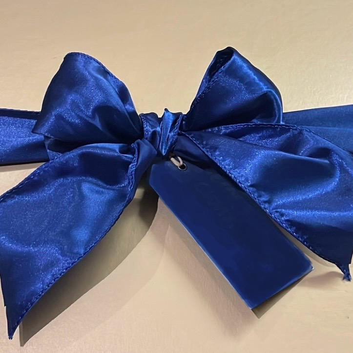 Blue satin bow on a beige background